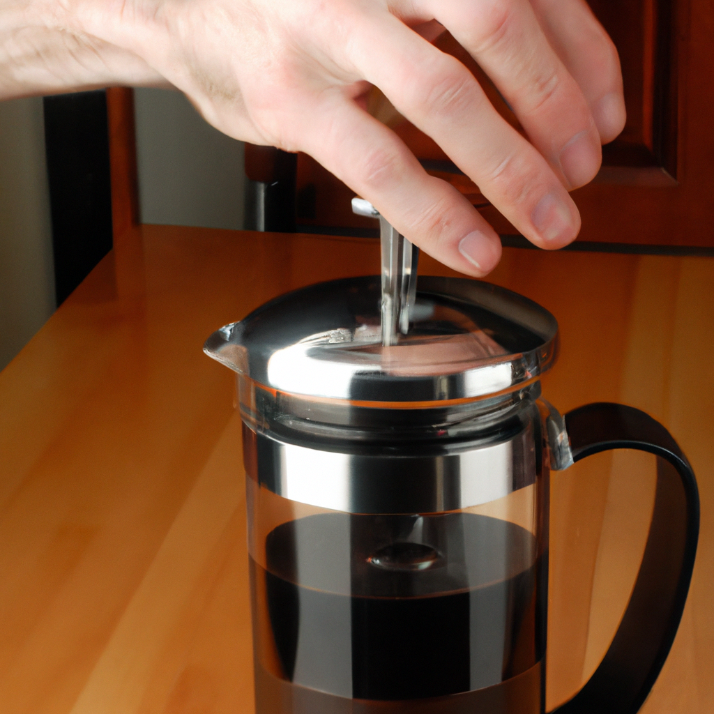 a french press - with really black coffee being pressed by a human hand